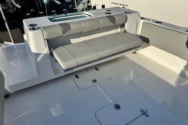 Slide: The Image of 2026 Cape Horn 34 XS boat interior with cushioned seating and storage compartments. - 21