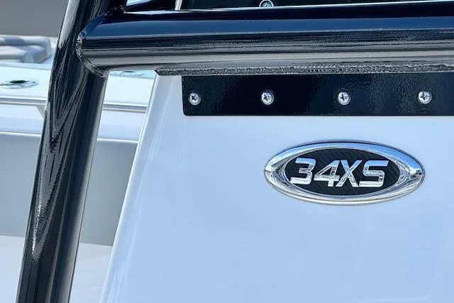 Slide: The Image of 2026 Cape Horn 34 XS boat emblem close-up with sleek design. - 4