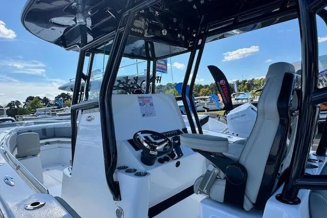 Slide: The Image of 2026 Cape Horn 34 XS boat interior with steering console and seating. - 8