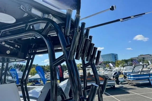 Slide: The Image of 2026 Cape Horn 34 XS boat with rod holders, displayed at a marina under clear blue skies. - 9