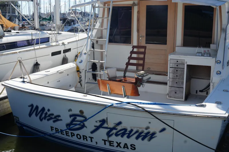 Slide: The Image of 1977 Bertram 46.6 yacht "Miss B Havin'" docked in Freeport, Texas marina. - 2