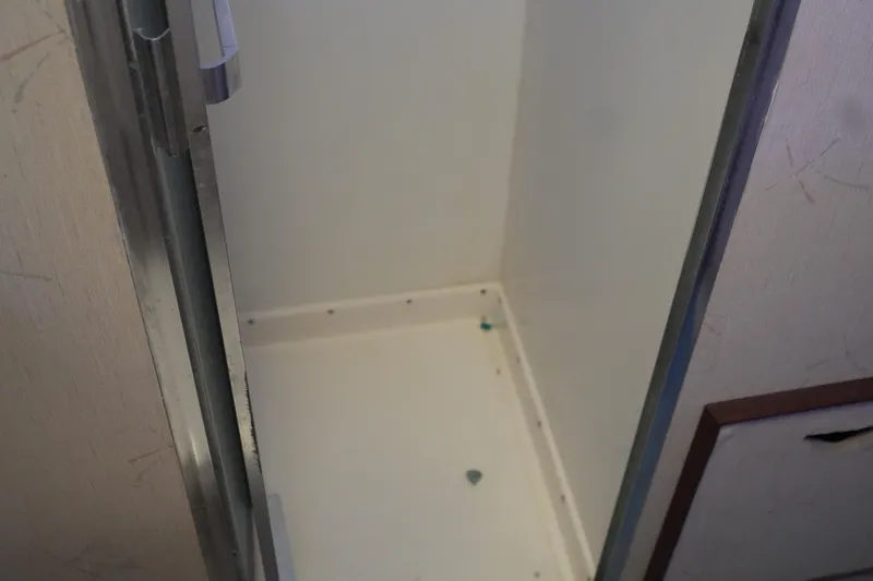 Slide: The Image of Empty interior compartment of a 1977 Bertram 46.6 boat. - 32