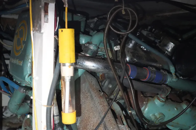 Slide: The Image of Engine compartment of a 1977 Bertram 46.6 boat, showcasing mechanical components and wiring. - 40