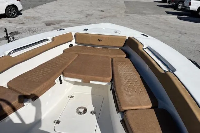 The Image of 2024 Sea Pro 199 Center Console boat with tan cushioned seating and spacious deck. - 1