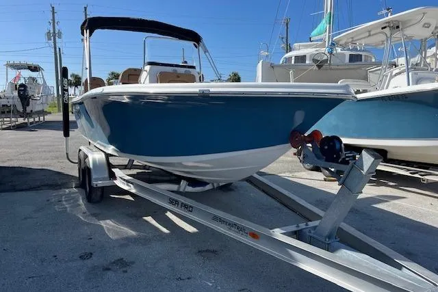 Slide: The Image of 2024 Sea Pro 199 Center Console boat on trailer, parked in marina. - 12