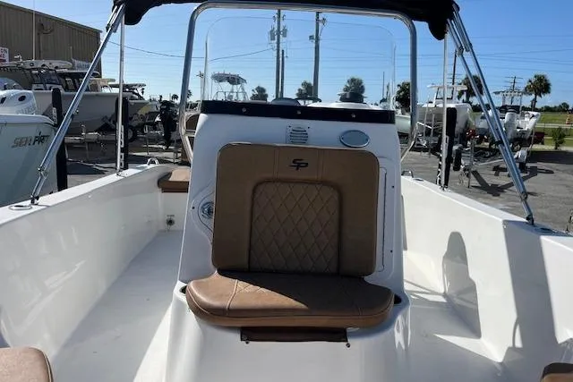 Slide: The Image of 2024 Sea Pro 199 Center Console boat with tan seating and sleek design. - 2