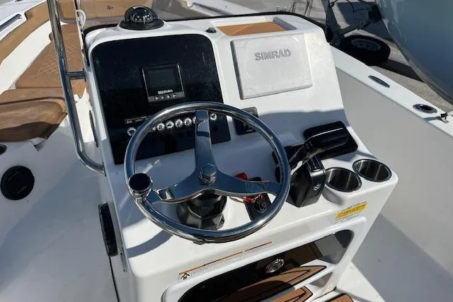 Slide: The Image of 2024 Sea Pro 199 Center Console boat dashboard with steering wheel and Simrad display. - 5