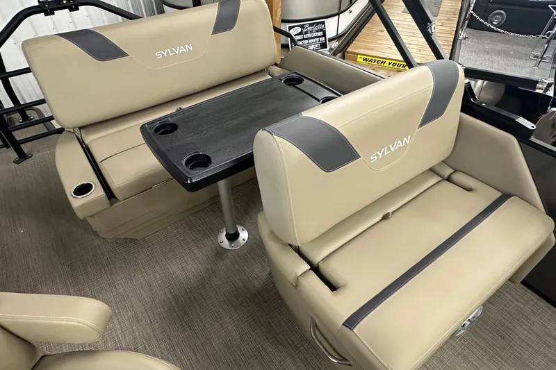 Slide: The Image of 2025 Sylvan L1 DLZ boat interior with beige seating and a central table. - 15