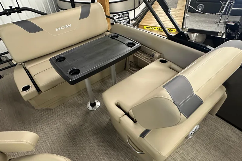 Slide: The Image of Luxurious seating area in 2025 Sylvan L1 DLZ boat with table and cup holders. - 16