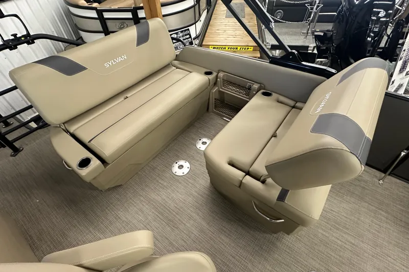 Slide: The Image of 2025 Sylvan L1 DLZ boat interior with beige seating and cup holders. - 18