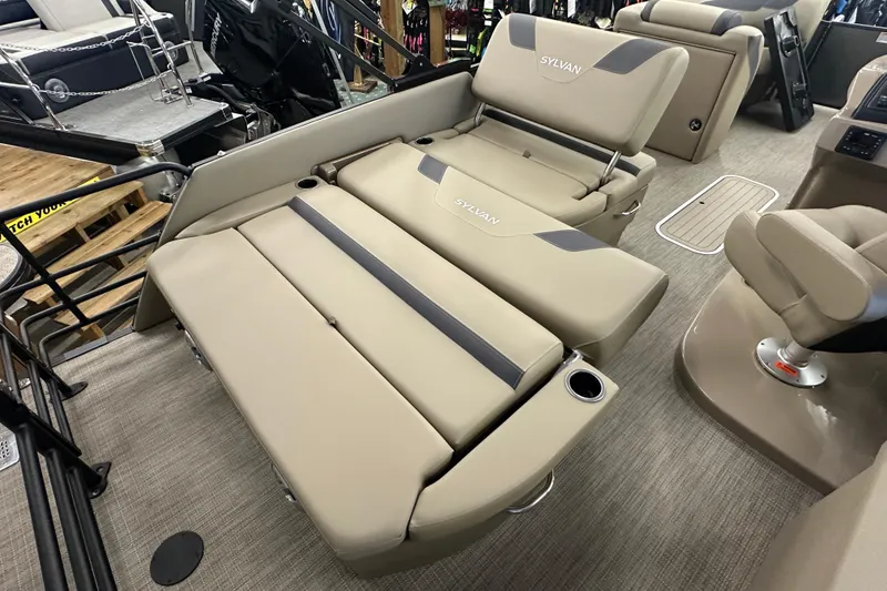 Slide: The Image of 2025 Sylvan L1 DLZ boat interior with beige seating and cup holders. - 21