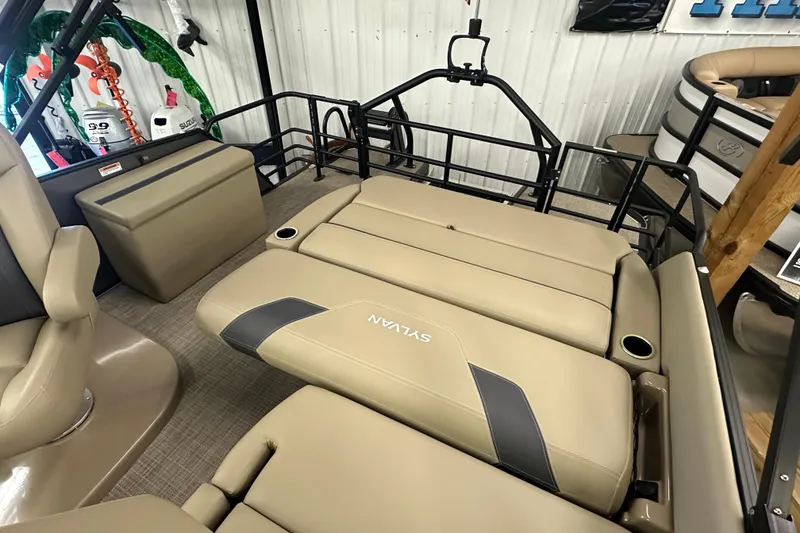 Slide: The Image of 2025 Sylvan L1 DLZ boat interior with beige seating and cup holders. - 22