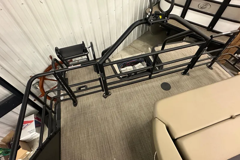 Slide: The Image of 2025 Sylvan L1 DLZ boat interior with railing and seating, in a storage area. - 23