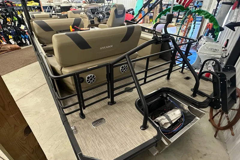 Slide: The Image of 2025 Sylvan L1 DLZ pontoon boat interior with beige seating and black railings. - 3