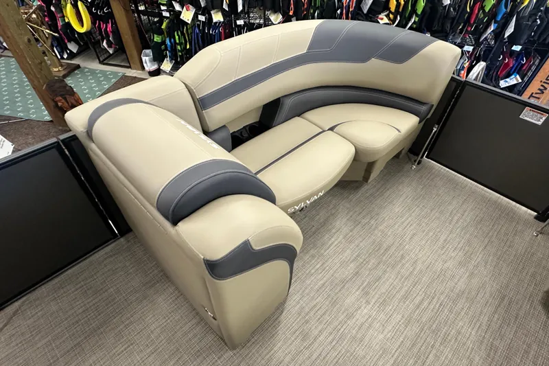 Slide: The Image of Luxurious seating in a 2025 Sylvan L1 DLZ boat, featuring beige and gray upholstery. - 6