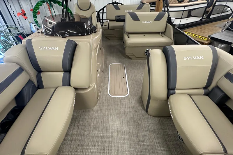 Slide: The Image of Luxurious interior of 2025 Sylvan L1 DLZ pontoon boat with beige seating. - 7