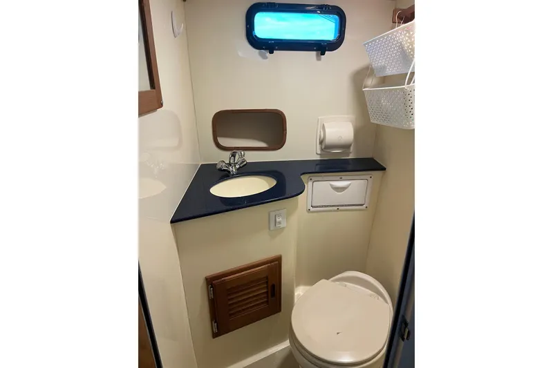 Slide: The Image of 2020 Eastern 27 Islander boat bathroom with sink, toilet, and storage. - 11