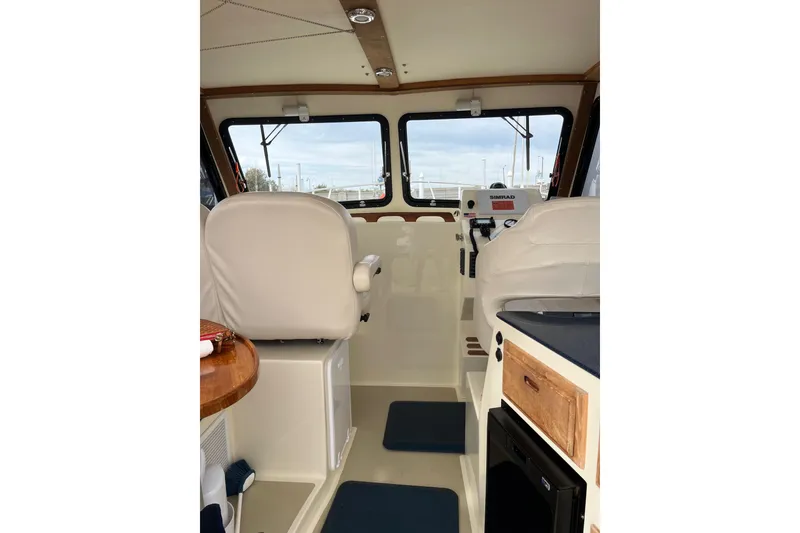 Slide: The Image of Interior of 2020 Eastern 27 Islander boat with white seating and navigation equipment. - 3