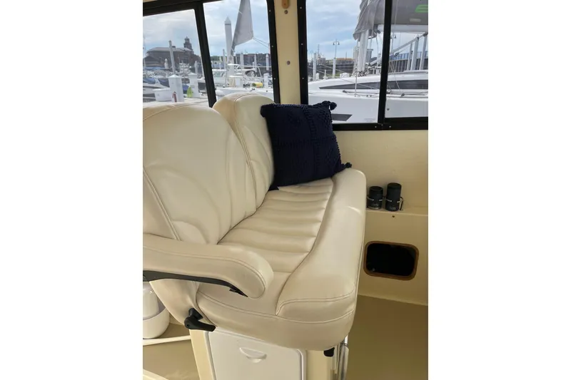 Slide: The Image of Luxurious interior seating of 2020 Eastern 27 Islander boat with plush cushion and window view. - 5