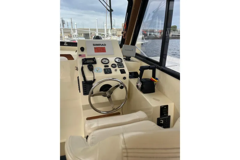 Slide: The Image of Helm of 2020 Eastern 27 Islander boat with navigation equipment and steering wheel. - 6
