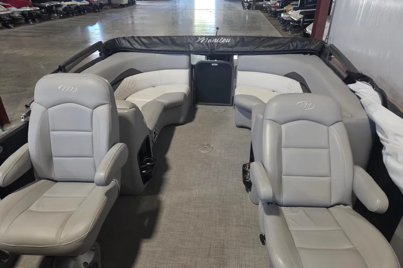 Slide: The Image of 2019 Manitou 23 Encore SHP pontoon boat interior with gray seating and spacious layout. - 2
