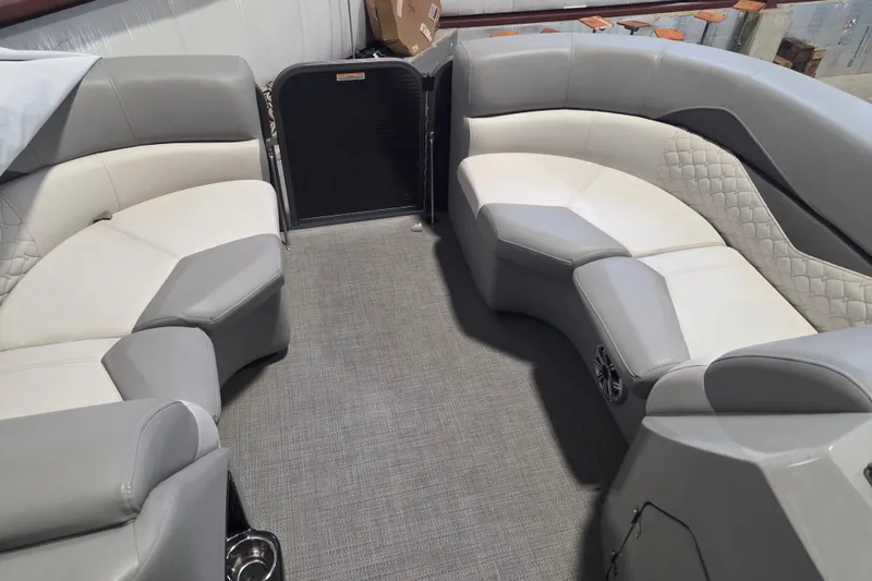 Slide: The Image of 2019 Manitou 23 Encore SHP boat interior with gray and white seating. - 6