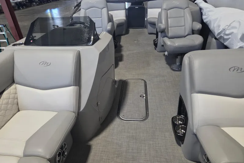 Slide: The Image of 2019 Manitou 23 Encore SHP pontoon boat interior with gray seating and carpeted floor. - 7