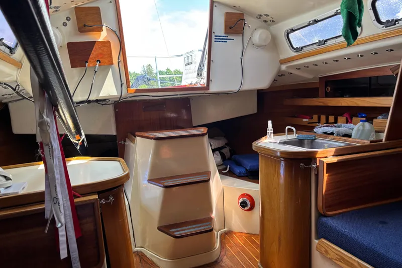 Slide: The Image of Interior of a 1982 J Boats J/30 sailboat, featuring a compact cabin with wooden finishes. - 3