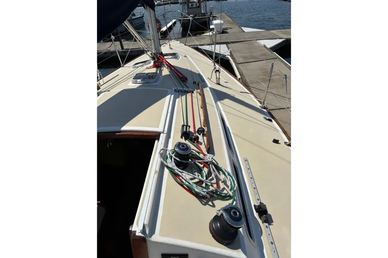 Slide: The Image of 1982 J Boats J/30 sailboat deck with ropes and winches at marina. - 5