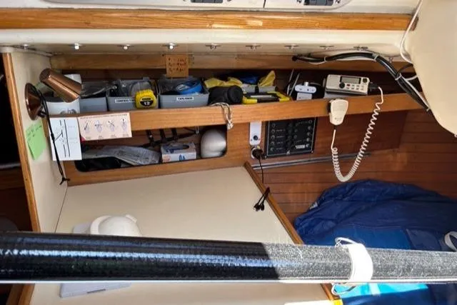 Slide: The Image of 1982 J Boats J/30 cabin interior with navigation equipment and storage shelves. - 9