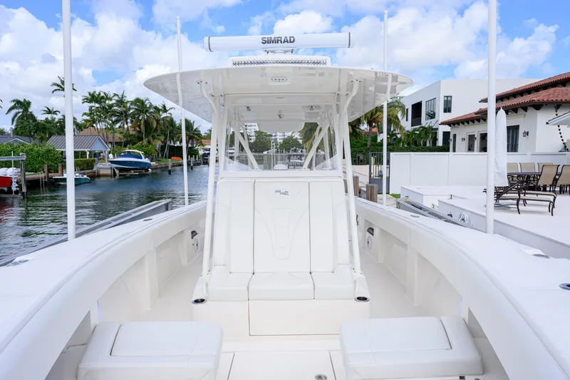 Slide: The Image of 2023 SeaVee 370z boat docked in a scenic waterfront setting. - 14