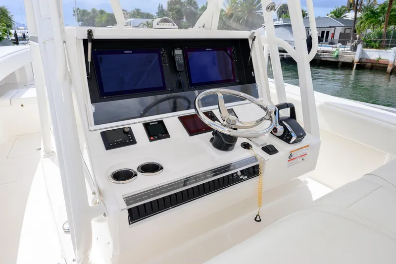Slide: The Image of 2023 SeaVee 370z boat console with dual screens and steering wheel. - 5