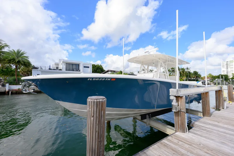 Slide: The Image of 2023 SeaVee 370z boat docked, featuring sleek blue hull and modern design. - 8