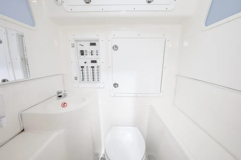 Slide: The Image of 2023 SeaVee 370z boat interior with control panel and compact bathroom. - 9