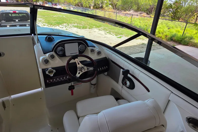 Slide: The Image of Interior view of 2009 Sea Ray 270 SLX boat cockpit with steering wheel and controls. - 10
