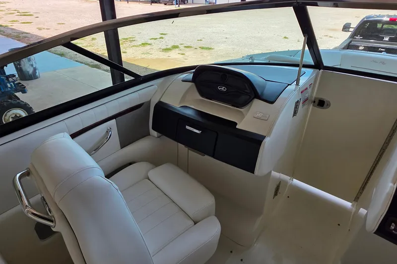 Slide: The Image of 2009 Sea Ray 270 SLX boat interior with white seating and dashboard. - 11