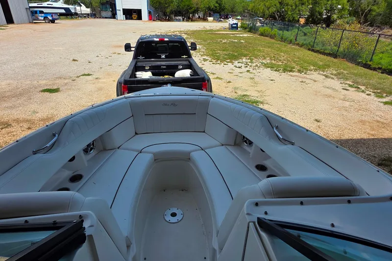 Slide: The Image of 2009 Sea Ray 270 SLX boat interior with a truck in the background. - 12