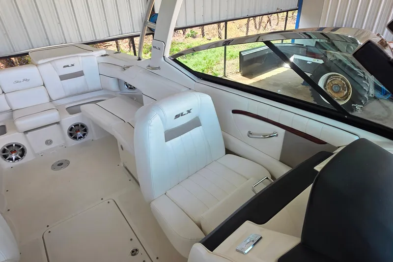 Slide: The Image of 2009 Sea Ray 270 SLX boat interior with white leather seating and modern design. - 13