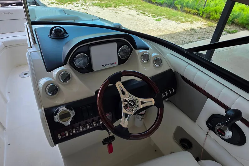 Slide: The Image of 2009 Sea Ray 270 SLX boat dashboard with steering wheel and control panel. - 17