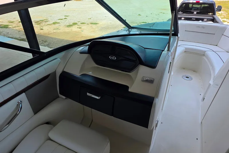 Slide: The Image of 2009 Sea Ray 270 SLX boat interior with white seating and dashboard. - 18
