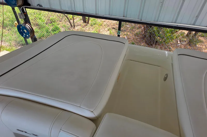 Slide: The Image of 2009 Sea Ray 270 SLX boat interior with white cushioned seating. - 22