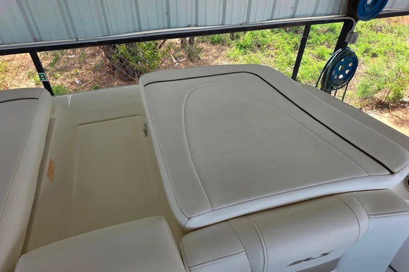 Slide: The Image of 2009 Sea Ray 270 SLX boat interior with white cushioned seating. - 23