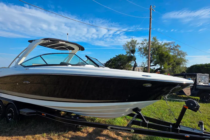 Slide: The Image of 2009 Sea Ray 270 SLX boat on trailer under clear blue sky. - 5