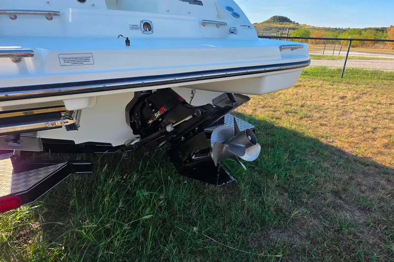 Slide: The Image of 2009 Sea Ray 270 SLX boat stern with propeller, parked on grass. - 7