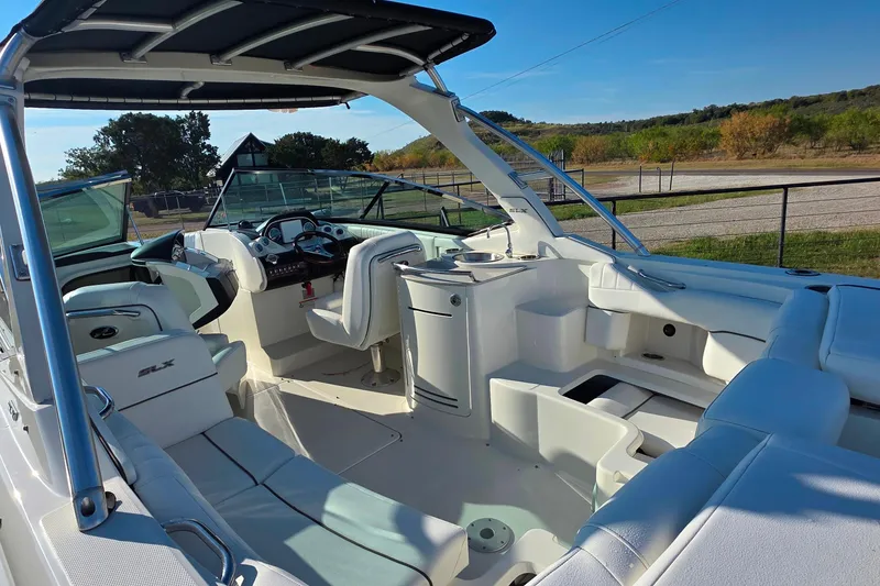 Slide: The Image of 2009 Sea Ray 270 SLX boat interior with white seating and modern dashboard. - 8