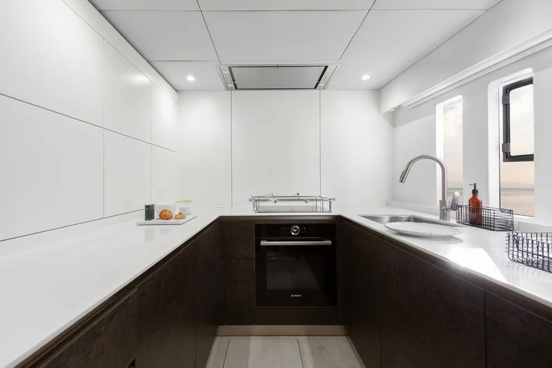 Slide: The Image of Modern kitchen interior on 2026 Sunreef 60 Sunreef Power yacht, featuring sleek design and appliances. - 16