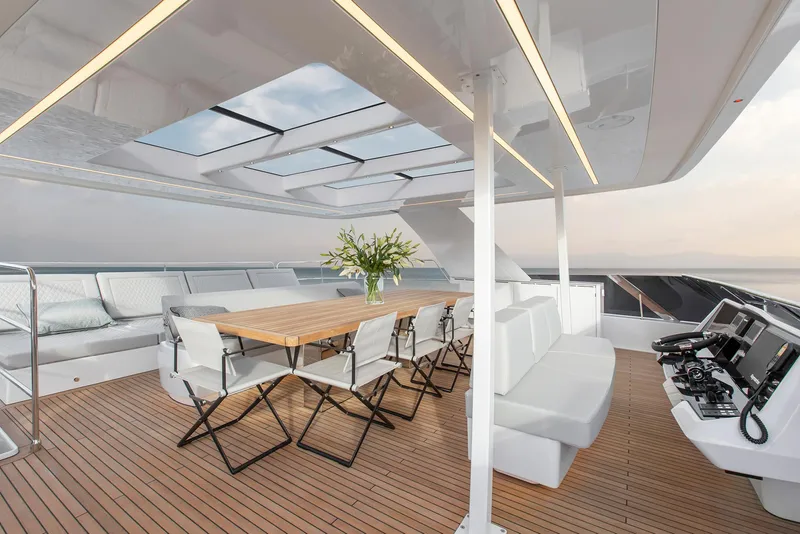 Slide: The Image of Luxurious 2026 Sunreef 60 Power yacht deck with elegant seating and dining area. - 3