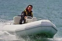 Slide: The Image of Person driving 2011 Bullfrog 10' Yacht Tender on water. - 6