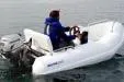 Slide: The Image of 2011 Bullfrog 10' Yacht Tender on water, featuring outboard motor and two passengers. - 7