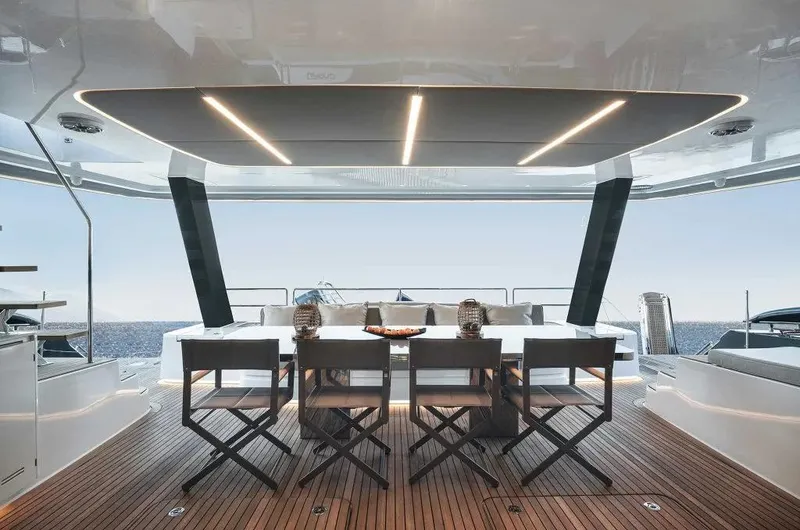 Slide: The Image of Luxurious 2026 Sunreef 70 Power yacht deck with elegant dining area and ocean view. - 9